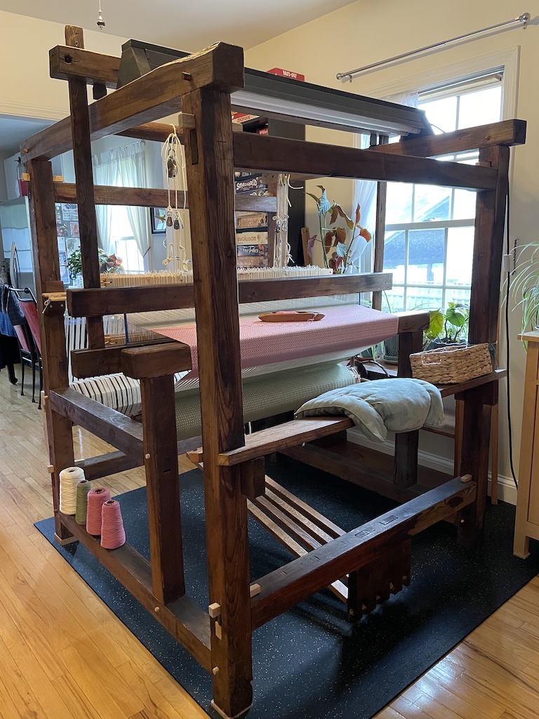 Weaver working at a floor loom